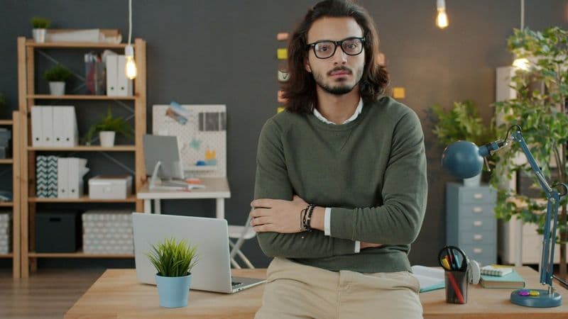 A business owner stands alone in a modern office