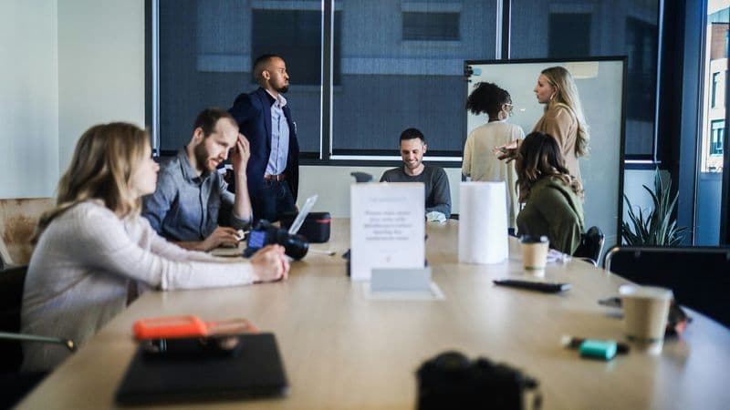 A business team works together around a conference table