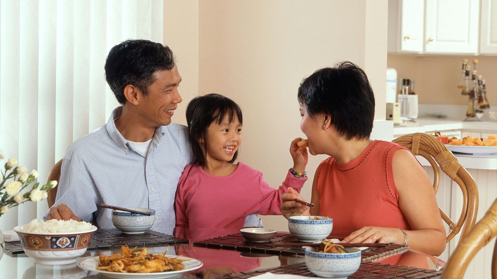 A family talks together while sharing a meal at the kitchen table