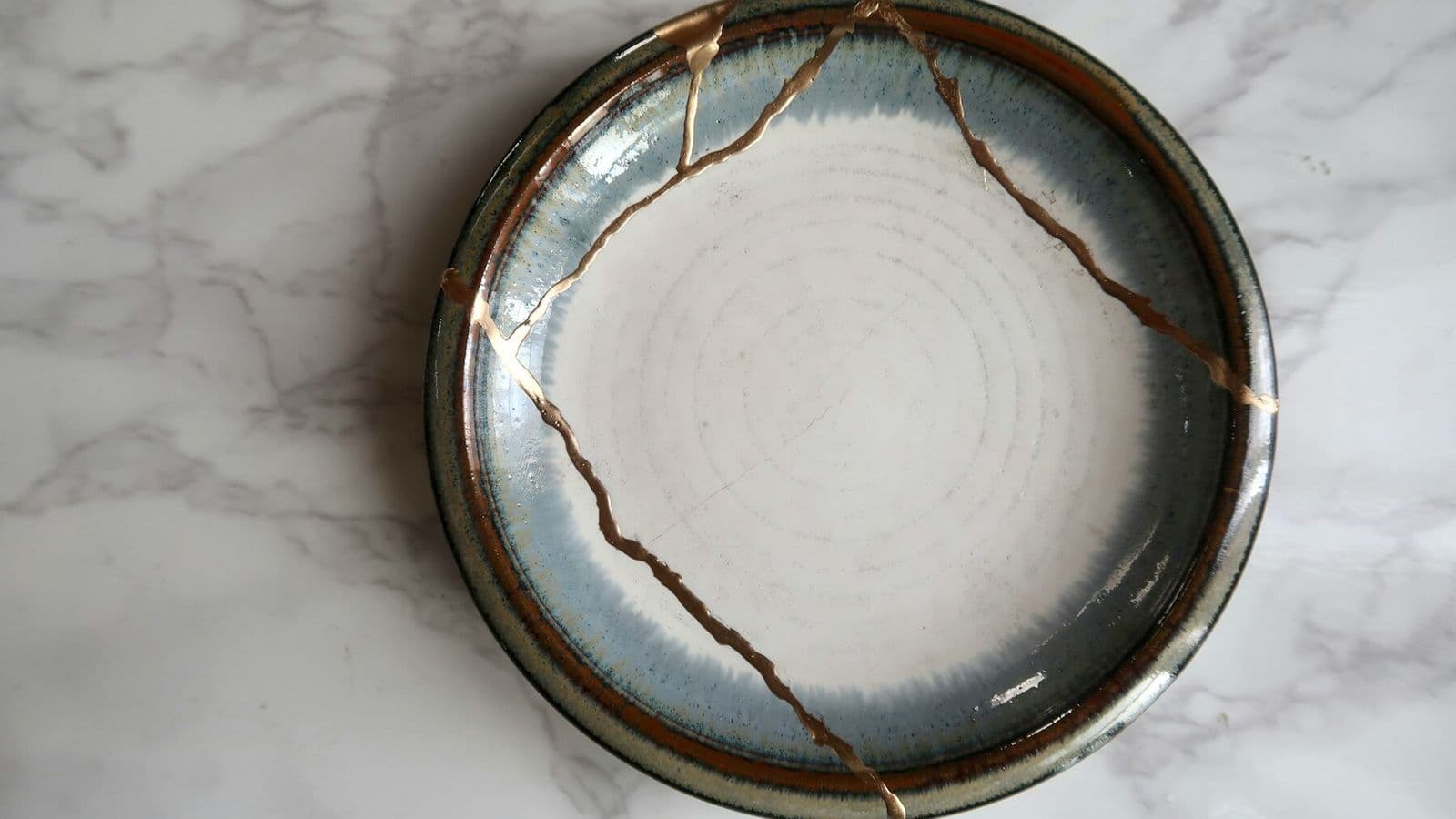 A ceramic bowl repaired with visible golden seams