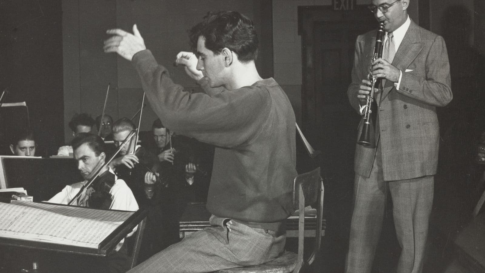 Leonard Bernstein conducting as Benny Goodman rehearses with an orchestra