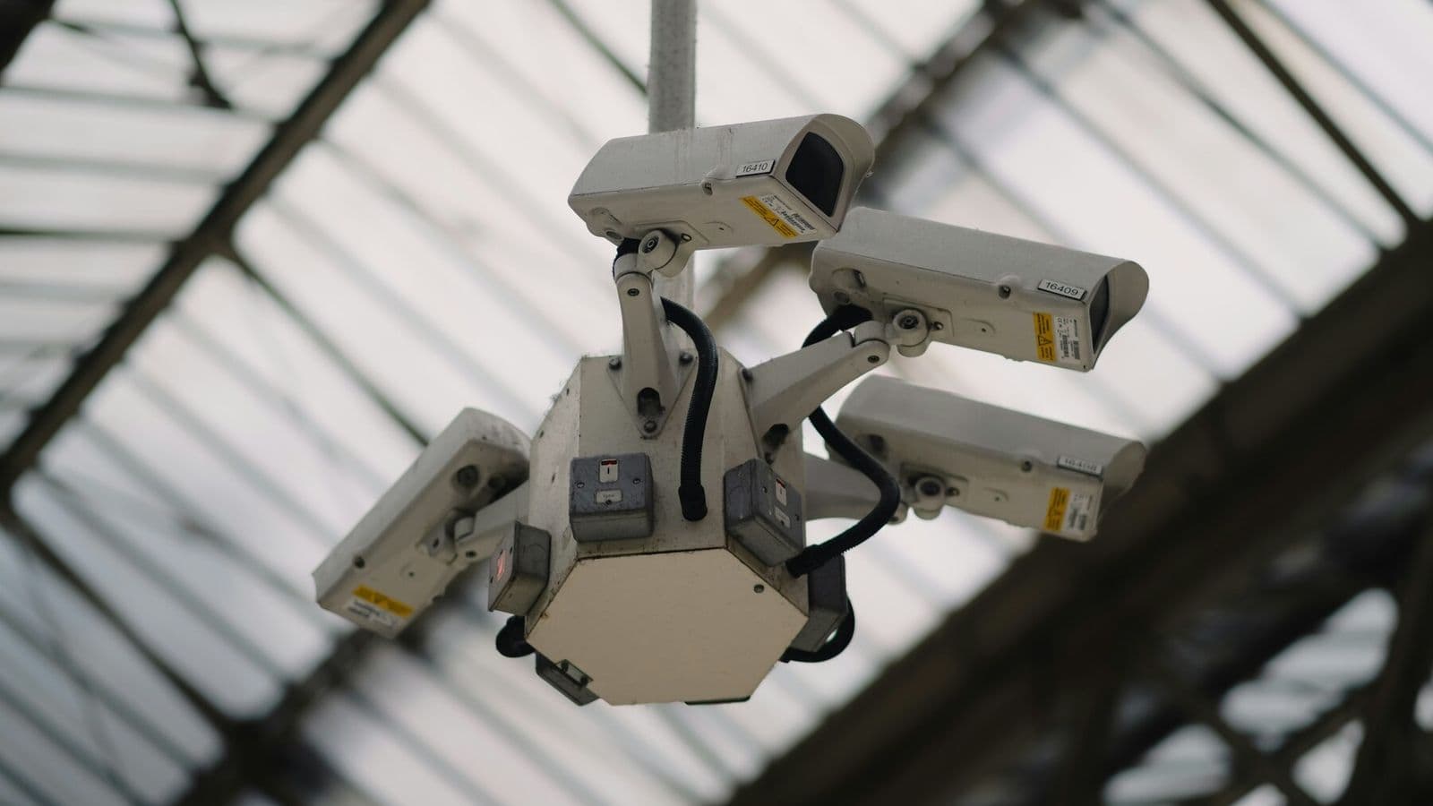 A cluster of surveillance cameras monitors a public interior